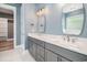 Bathroom features double vanities, marble countertops, sleek mirrors, and tile flooring at 1201 Surf Pointe Dr., North Myrtle Beach, SC 29582
