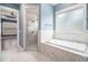 Bathroom featuring a soaking tub, tiled shower, and tile flooring at 1201 Surf Pointe Dr., North Myrtle Beach, SC 29582