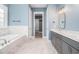 Bathroom features a soaking tub, double vanity, marble countertops, and tile flooring at 1201 Surf Pointe Dr., North Myrtle Beach, SC 29582
