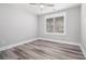 Bright bedroom features wood-look flooring, neutral walls, and a window with views at 1201 Surf Pointe Dr., North Myrtle Beach, SC 29582