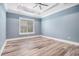 Bedroom features tray ceiling, ceiling fan, plush carpet, blue walls, and plantation shutters at 1201 Surf Pointe Dr., North Myrtle Beach, SC 29582
