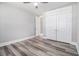 This bedroom features wood-look floors, neutral walls, a ceiling fan, and closet storage at 1201 Surf Pointe Dr., North Myrtle Beach, SC 29582