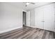 This bedroom features wood-look floors, neutral walls, a ceiling fan, and closet storage at 1201 Surf Pointe Dr., North Myrtle Beach, SC 29582