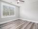 Bright bedroom features wood-look flooring, neutral walls, and a window with views at 1201 Surf Pointe Dr., North Myrtle Beach, SC 29582