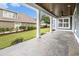 View of the outdoor covered patio featuring stone floors, ceiling fan, and ample space for entertaining at 1201 Surf Pointe Dr., North Myrtle Beach, SC 29582