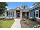Inviting front entrance with stone accents, well-maintained landscaping, and a decorative front door at 1201 Surf Pointe Dr., North Myrtle Beach, SC 29582