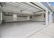 Spacious garage with epoxy flooring, overhead storage racks, and ample room for vehicles at 1201 Surf Pointe Dr., North Myrtle Beach, SC 29582