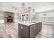 Modern kitchen island with stone countertops, stainless steel appliances, and elegant pendant lighting at 1201 Surf Pointe Dr., North Myrtle Beach, SC 29582