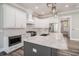 Bright kitchen featuring white cabinets, marble countertops, stainless steel appliances, and pendant lighting at 1201 Surf Pointe Dr., North Myrtle Beach, SC 29582
