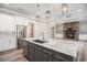 Modern kitchen featuring an island with marble countertop, stainless steel appliances, and sleek white cabinets at 1201 Surf Pointe Dr., North Myrtle Beach, SC 29582