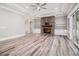 Bright living room featuring a stone fireplace, built-in shelving, and sliding glass doors at 1201 Surf Pointe Dr., North Myrtle Beach, SC 29582