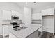 Modern kitchen with white cabinets, granite countertops, and stainless steel appliances at 197 Six Mile Creek Dr., Georgetown, SC 29440
