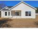 Backyard featuring white siding, multiple windows, and a concrete patio at 2770 Daisy Rd., Loris, SC 29569