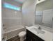 Bright bathroom featuring a tub, shower combo, and a modern vanity with a dark wood cabinet at 2770 Daisy Rd., Loris, SC 29569