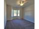 Cozy bedroom featuring a large bay window, plush carpeting, and a neutral color scheme at 2770 Daisy Rd., Loris, SC 29569