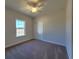 Inviting bedroom with plush carpet, closet, and large window offering lots of natural light at 2770 Daisy Rd., Loris, SC 29569