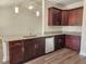 Well-equipped kitchen boasts ample counter space, stainless steel appliances, and sleek dark-toned cabinets at 2770 Daisy Rd., Loris, SC 29569