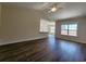 Open-concept living room featuring wood floors and a partial wall with a bar to the kitchen area at 2770 Daisy Rd., Loris, SC 29569