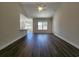 Open-concept living room with wood floors, connecting seamlessly to the kitchen area, and neutral walls at 2770 Daisy Rd., Loris, SC 29569