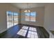 Sunlit dining area with modern chandelier, large windows, and sliding glass door at 2778 Daisy Rd., Loris, SC 29569