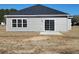 Backyard view showing the home's siding, windows, and sliding glass door to the patio at 2808 Daisy Rd., Loris, SC 29569