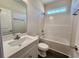Bright bathroom featuring white fixtures, a combo shower-tub, and modern vanity with a white countertop at 2808 Daisy Rd., Loris, SC 29569