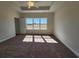 Bright bedroom featuring a ceiling fan, large windows, and neutral carpet at 2808 Daisy Rd., Loris, SC 29569