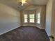 Bright bedroom with a vaulted ceiling, three windows, and neutral carpeting, a cozy space at 2808 Daisy Rd., Loris, SC 29569
