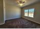 A serene bedroom with plush brown carpet and a large window offering abundant natural light at 2808 Daisy Rd., Loris, SC 29569