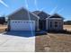 Charming one-story home with a two-car garage and manicured front lawn, offering comfortable living at 2808 Daisy Rd., Loris, SC 29569
