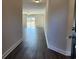 Hallway view into a spacious living area with hardwood floors and natural light at 2808 Daisy Rd., Loris, SC 29569