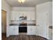 Modern kitchen with white cabinets, granite countertops, and stainless steel appliances at 2808 Daisy Rd., Loris, SC 29569