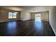 Spacious living room featuring dark wood floors, a ceiling fan, and natural light from the backyard sliding door at 2808 Daisy Rd., Loris, SC 29569