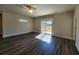 Spacious living room boasts a ceiling fan and sliding glass doors that let in lots of natural light at 2808 Daisy Rd., Loris, SC 29569