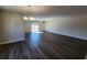 Open living room area with chandelier, ceiling fan, and sliding glass doors allowing natural light at 2808 Daisy Rd., Loris, SC 29569