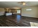 Spacious living area with kitchen island, stainless appliances, and hardwood flooring at 2808 Daisy Rd., Loris, SC 29569