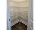 A spacious pantry featuring metal shelving and wood-look flooring at 2808 Daisy Rd., Loris, SC 29569