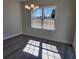 Bright dining area featuring wood floors, a chandelier, and a large window for plenty of natural light at 2814 Daisy Rd., Loris, SC 29569