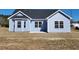 Exterior of blue home with white trim, windows, and black roof at 2814 Daisy Rd., Loris, SC 29569