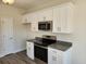 Modern kitchen featuring white cabinetry, granite countertops, and stainless steel appliances at 2814 Daisy Rd., Loris, SC 29569