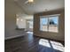 Open-concept living room with natural light, wood floors, and a view of the modern kitchen at 2814 Daisy Rd., Loris, SC 29569