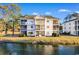 Condo building, Unit 2F highlighted, with balcony and water view at 597 Blue River Ct. # 2F, Myrtle Beach, SC 29579