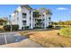 Attractive 3-story building with inviting landscaping and water views at 597 Blue River Ct. # 2F, Myrtle Beach, SC 29579