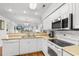 Open concept kitchen with white cabinets and stainless steel appliances at 597 Blue River Ct. # 2F, Myrtle Beach, SC 29579
