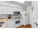 Clean and bright kitchen with white cabinets and stainless steel appliances at 597 Blue River Ct. # 2F, Myrtle Beach, SC 29579