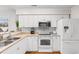 Well-equipped kitchen with white cabinets, stainless steel appliances, and a breakfast bar at 597 Blue River Ct. # 2F, Myrtle Beach, SC 29579