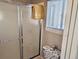 Bright bathroom with shower and commode, featuring patterned wallpaper and natural light from a nearby window at 100 G Myrtle Greens Dr. # G, Conway, SC 29526