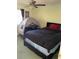 Cozy bedroom featuring a bed with dark linens, a ceiling fan, and a tent for a play area at 100 G Myrtle Greens Dr. # G, Conway, SC 29526