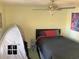 Bright bedroom featuring a bed with dark linens, a ceiling fan, and a tent for a play area at 100 G Myrtle Greens Dr. # G, Conway, SC 29526