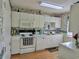 Functional kitchen featuring white cabinetry, white appliances, and a stylish backsplash and flooring at 100 G Myrtle Greens Dr. # G, Conway, SC 29526